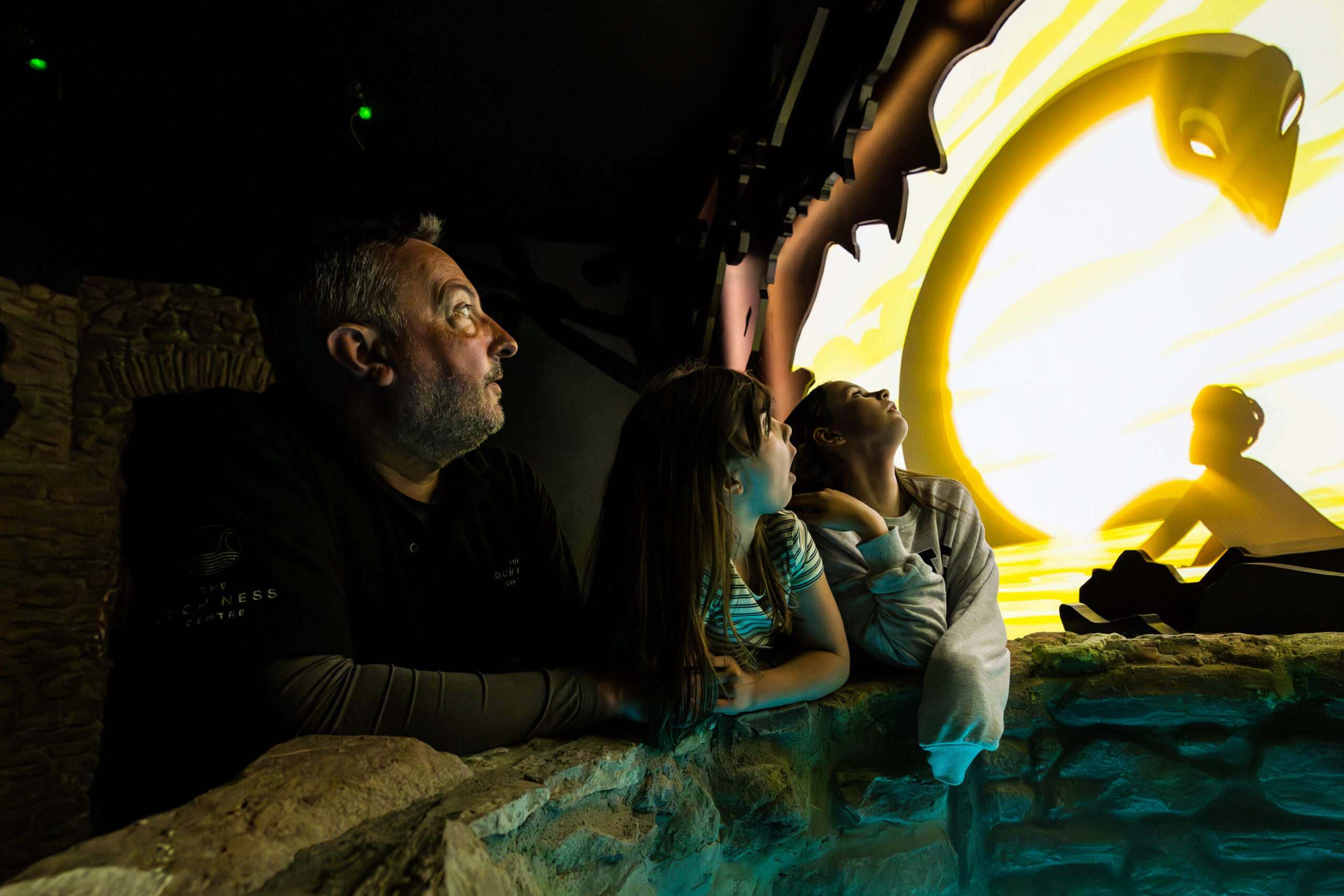 Family Listen To Stories Of Nessie In The Loch Ness Centre Scaled